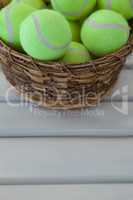 High angle view of fluorescent yellow tennis balls in wicker basket