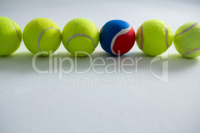 Tennis balls arranged on white background