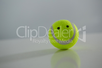Close up of tennis ball with anthropomorphic face