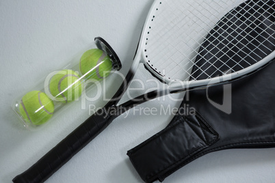High angle view of tennis racket by balls in container