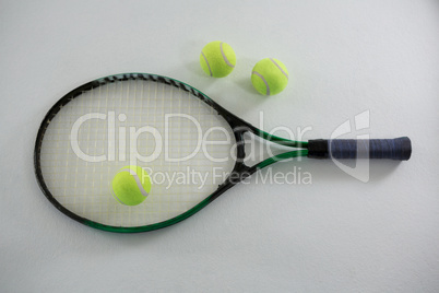 Overhead view of tennis balls with racket