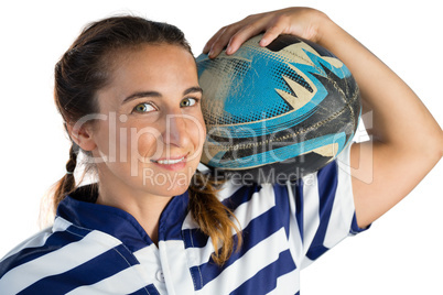 Portrait of smiling female player holding rugby ball