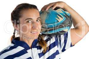Portrait of smiling female player holding rugby ball