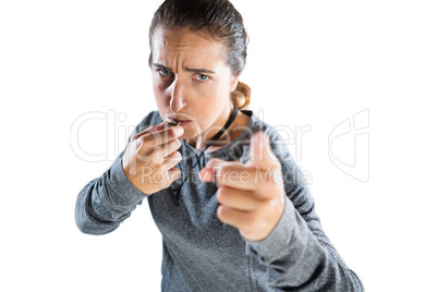 High angle portrait of female coach gesturing while whistling