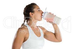 Female athlete drinking energy drink