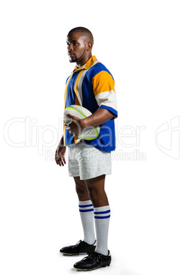 Side view of confident rugby player holding ball