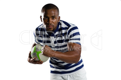 Portrait of young sportsman with ball running while playing rugby