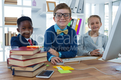 Kids as business executives working together in office