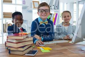 Kids as business executives working together in office