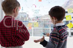 Kids as business executives discussing over whiteboard