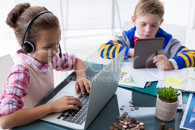 Kids as business executives working together in office