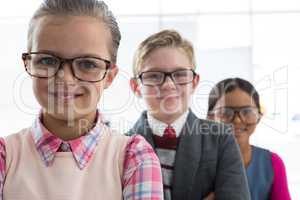 Kids as business executive smiling while standing in the office