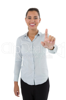 Female executive pressing an invisible virtual screen