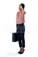 Female executive standing with briefcase