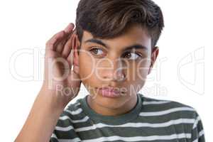 Teenage boy listening secretly with hands behind her ears