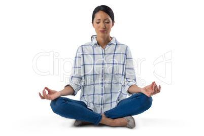 Woman performing yoga against white background