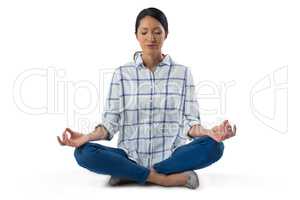 Woman performing yoga against white background