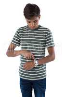 Teenage boy operating his smartwatch