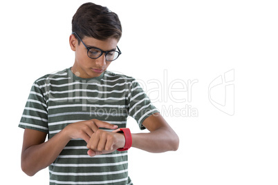 Teenage boy operating his smartwatch