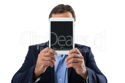 Businessman hiding her face behind digital tablet