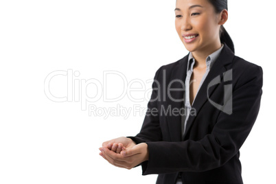 Smiling businesswoman with hand cupped against white background
