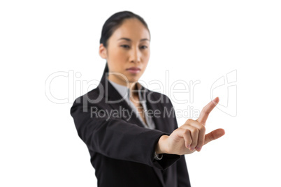 Businesswoman pressing an invisible virtual screen