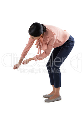 Female executive pretending to be holding invisible object