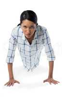Woman performing push-ups against white background