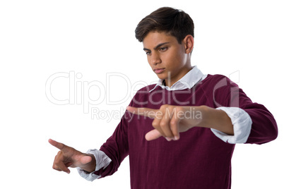 Teenage boy touching an invisible screen