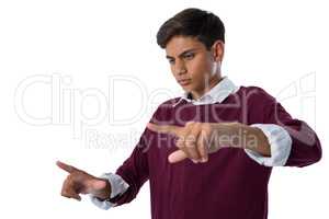 Teenage boy touching an invisible screen