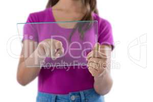 Teenage girl using glass digital tablet against white background