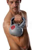 Determined shirtless sportsman exercising with kettle bell