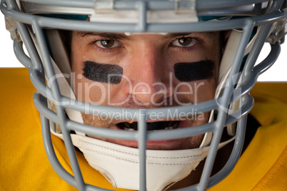 Close-up portrait of determined American football player wearing helmet