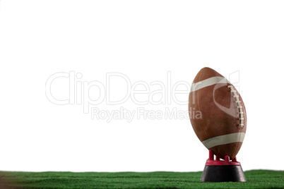 American football on tee against white background