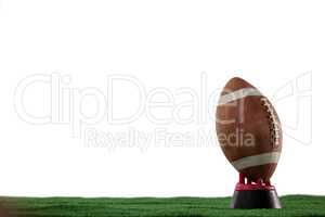 American football on tee against white background