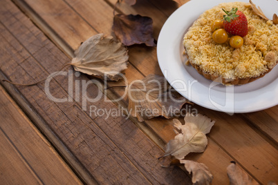 Autumn leaves with breakfast on wooden table