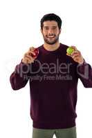 Portrait of smiling man holding apple