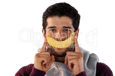 Portrait of smiling man holding banana