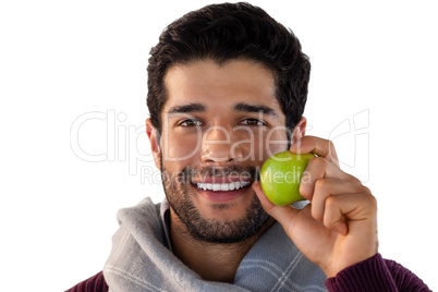 Close-up of smiling man holding apple