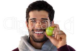 Close-up of smiling man holding apple