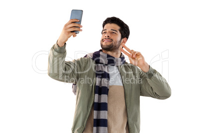 Smiling man taking selfie from mobile phone