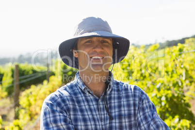 Handsome farmer smiling in field on a sunny day