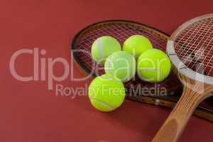 High angle view of tennis balls with wooden rackets