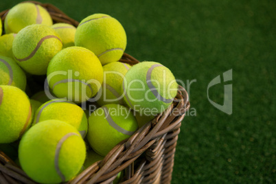 Close up of tennis balls in wicker basket