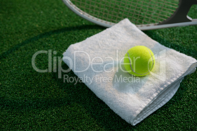 Tennis ball on napkin by racket