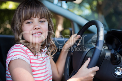 Happy teenage girl driving a car
