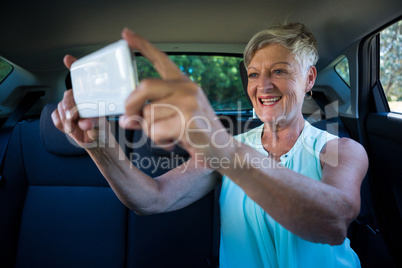 Senior woman taking selfie on mobile phone