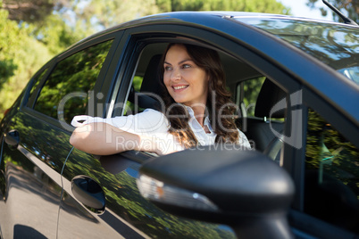 Woman smiling while driving a car