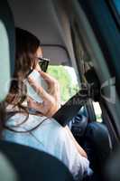 Woman talking on mobile phone while driving a car