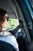 Smiling woman driving a car